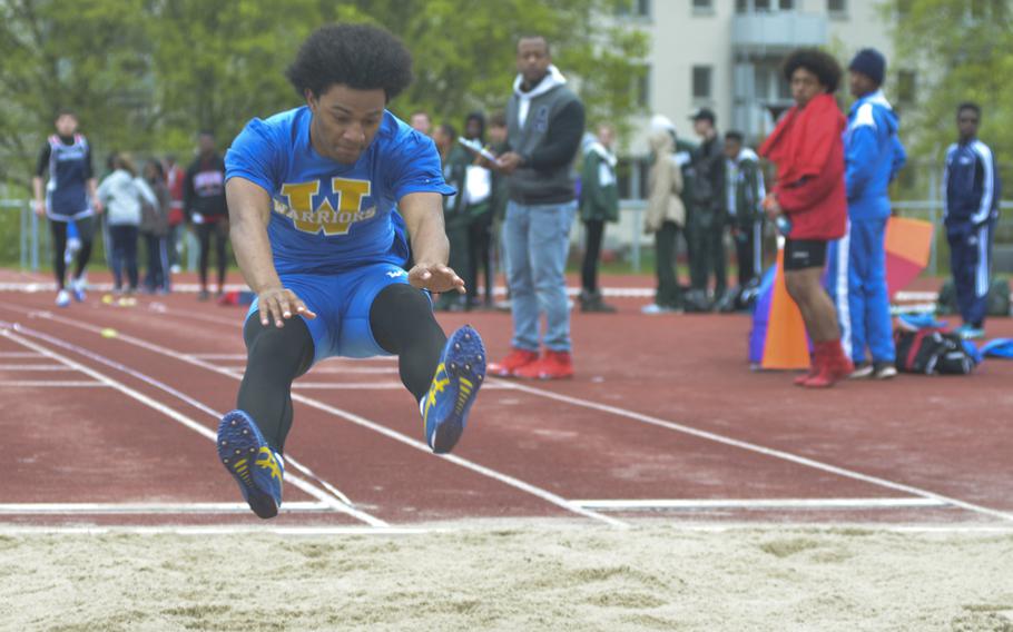 Joshua Theodore of Wiesbaden extends during the long jump event during an 11-team meet at Wiesbaden, Saturday, April 23, 2016. Theodore was one of three athletes to come in to the meet with a 19-foot or longer jump in the previous meet.