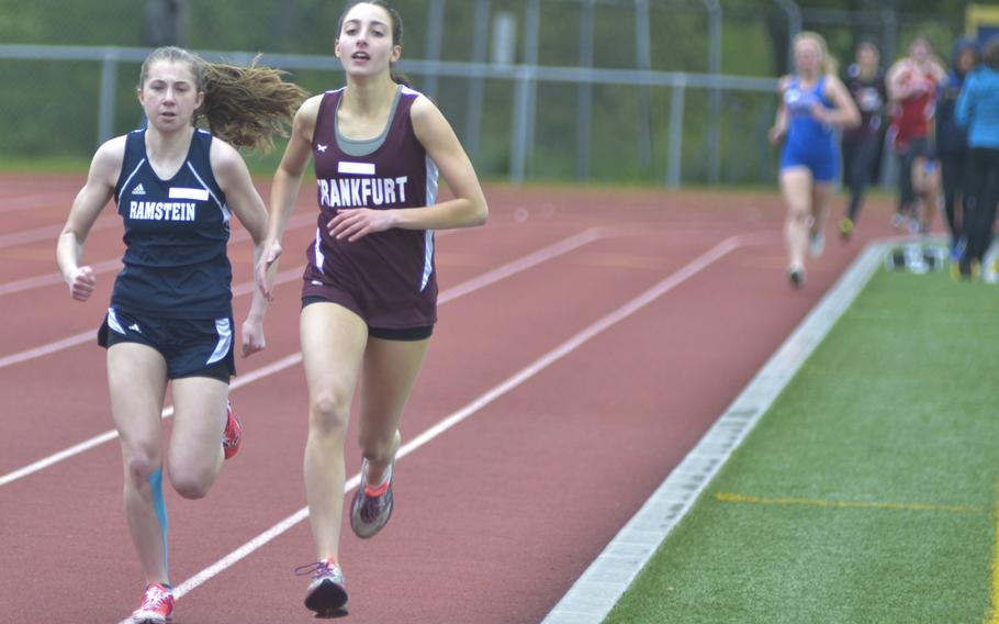 Katelyn Schultz of Ramstein, left, and Julia Karcher of Frankfurt International School, right, contend in the girls 800-meter run during an 11-team meet at Wiesbaden, Saturday, April 23, 2016. Schultz eventually pulled away from Karcher, who finished second.