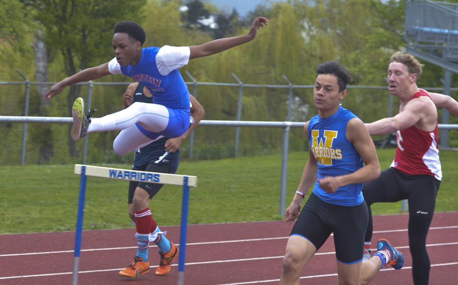 Joel Waan of Wiesbaden, second from right, takes the lead in the boys' 300-meter hurdles during an 11-team meet at Wiesbaden, Saturday, April 23, 2016. Waan swept the hurdle events, winning this and the 110-meters.
