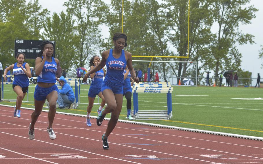 Ramstein's Denee Lawrence crosses the finish line first in the girls' 100-meter dash during an 11-team meet at Wiesbaden, Saturday, April 23, 2016. Lawrence and Ramstein also took top honors in the 4x100-meter relay.