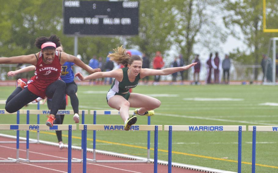 Jada Branch, left, of Kaiserslautern, and Olivia Sealey, right, of Alconbury, contend in the girls' 100-meter hurdles during an 11-team meet at Wiesbaden, Saturday, April 23, 2016. Sealey won the race with a time of 17.52 seconds.