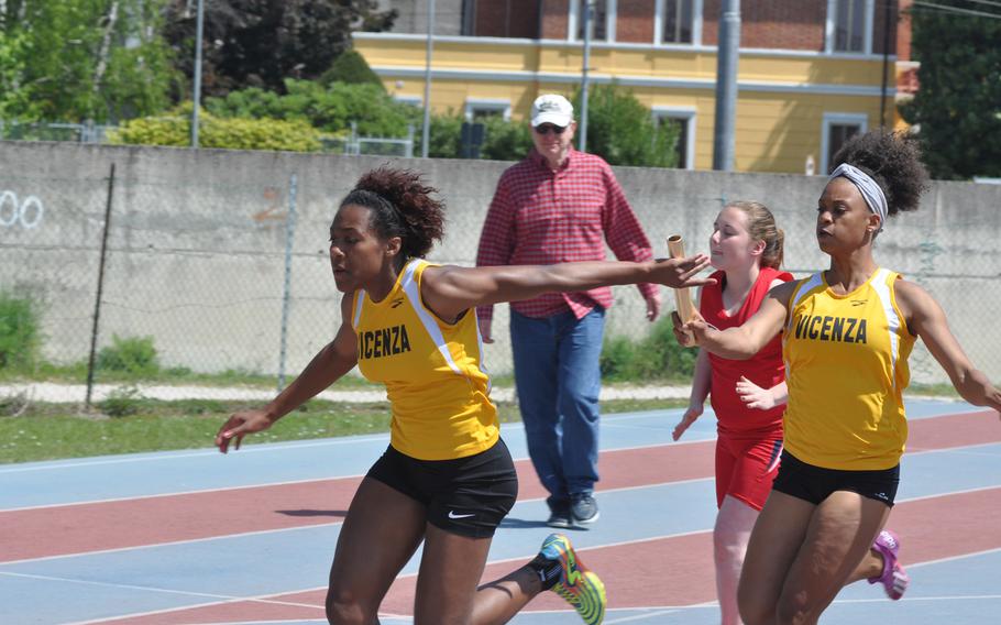 Vicenza's DeAsia Fairley, left, takes a handoff from Altasia Thompson in the girls 4x100 relay event won by the Cougars.