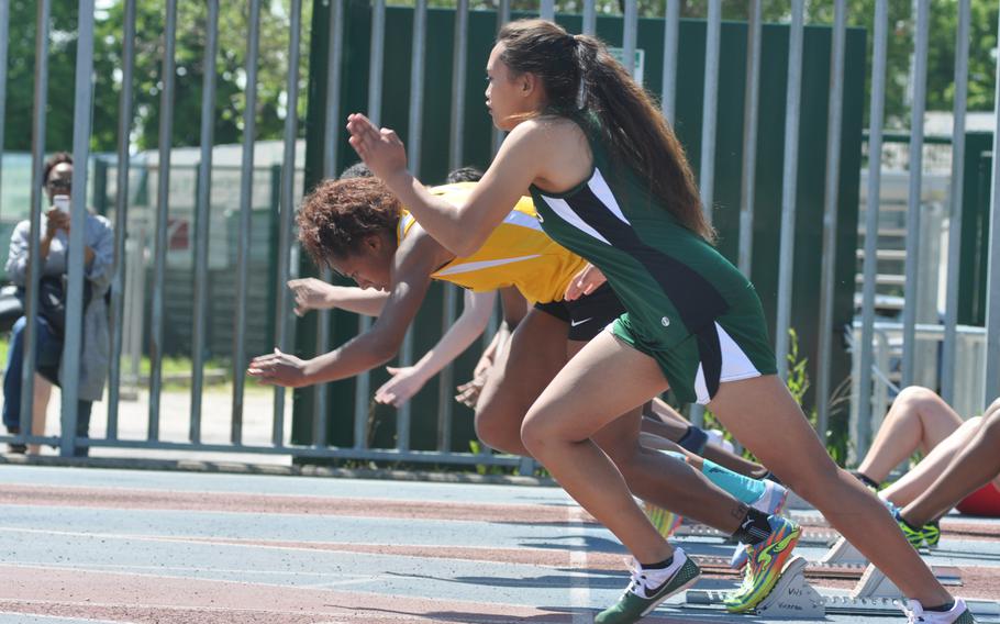 Runners lunge off the blocks at the start of the first heat of the girls 100-meter run on Saturday in Pordenone, Italy.