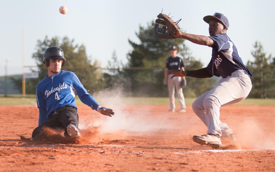 Hohenfels' Jared Johnson slides in as Bitburg's Jermain Cooks waits for the throw to arrive during a DODEA-Europe doubleheader at Hohenfels, Germany, Friday, May 6, 2016. 