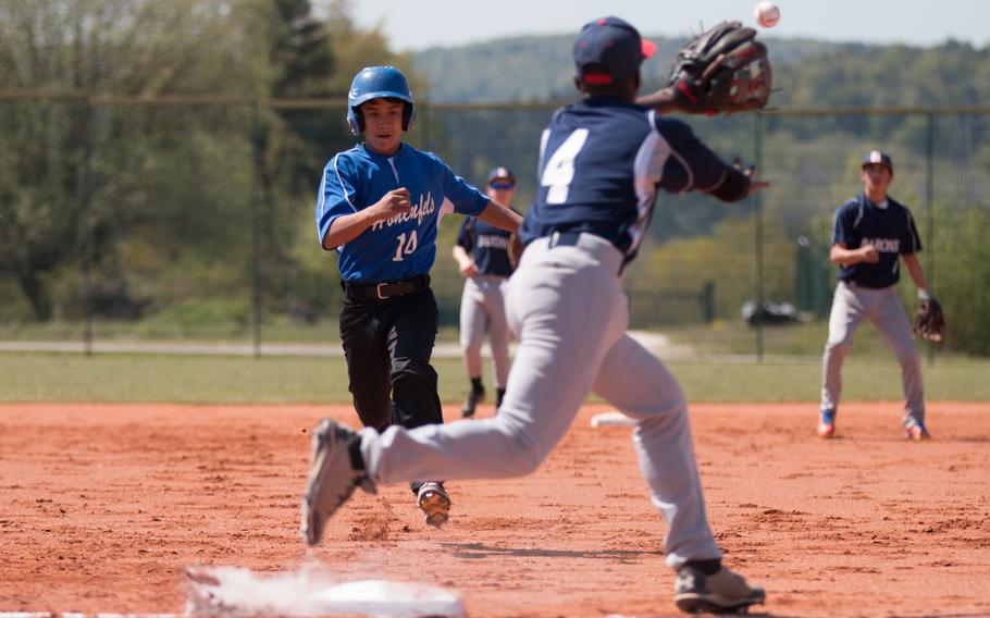 Hohenfels' Michael Wall tries to beat the throw to third as Bitburg's Jermain Cooks stretches out for the ball during a DODEA-Europe doubleheader at Hohenfels, Germany, Friday, May 6, 2016. 