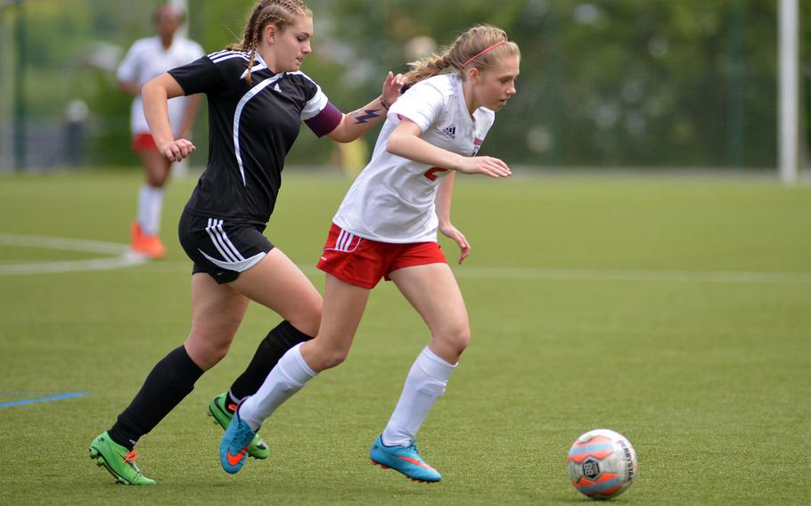 Kaiserslautern's Chloe Delany, right, tries to get away from Vicenza's Tory Brock in an opening day Division I game at the DODEA-Europe soccer championships in Reichenbach-Steegen, Germany, Wednesday, May 18, 2016. Kaiserslautern won 2-1.