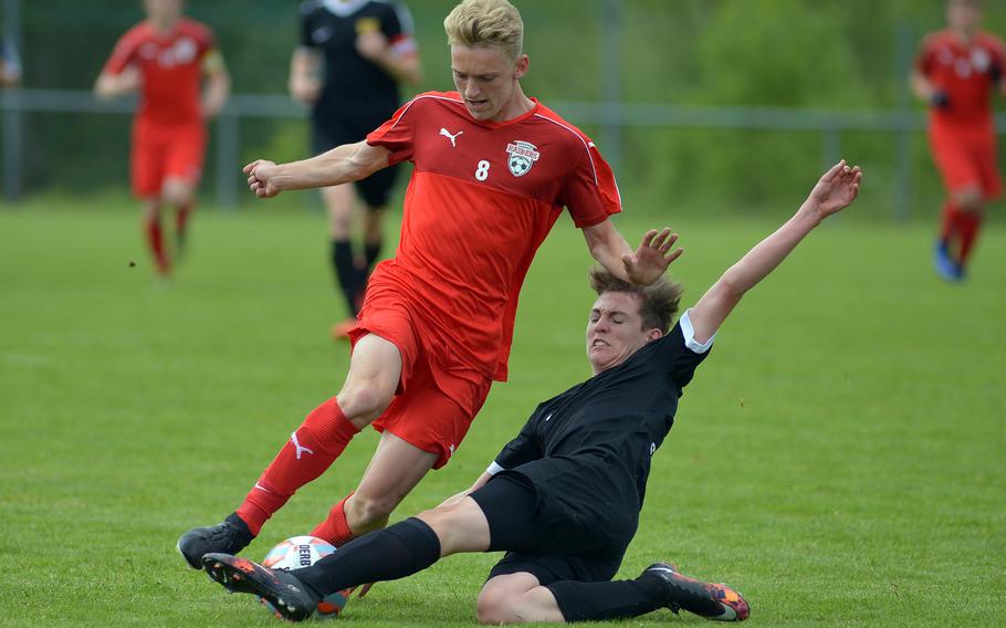 Stuttgart's Jacob Wilson slides in to stop Kaiserslautern's Tyler Jankowski in a Division I game on opening day of the DODEA-Europe soccer championships in Reichenbach-Steegen, Germany, Wednesday, May 18, 2016. Kaiserslautern won 3-1.