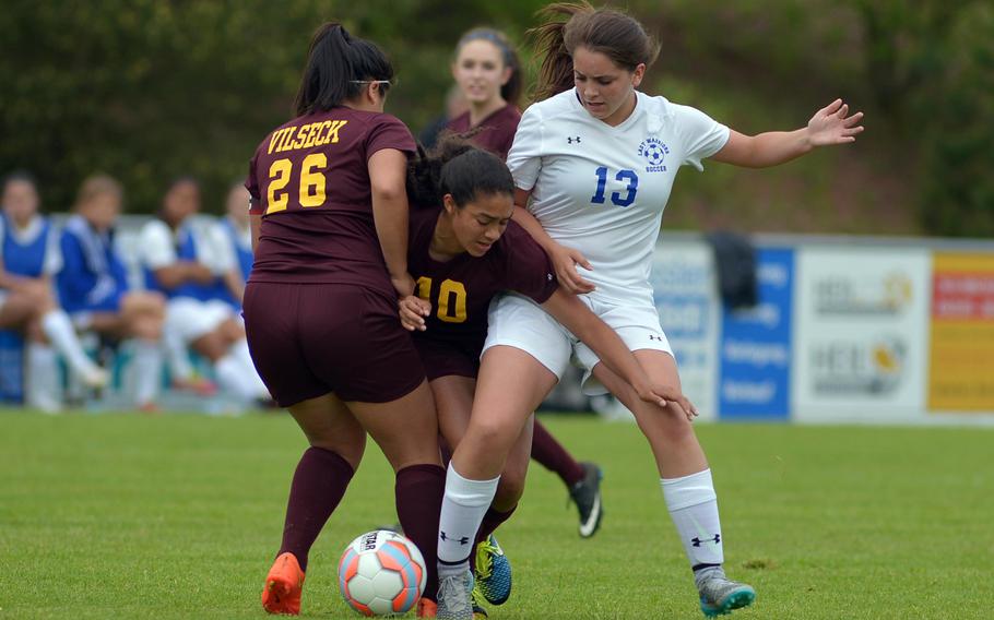 Vilseck's Jennifer Bueno, left, and Adely Huezo tie up Wiesbaden's Camryn Hickson in a girls Division I game on opening day of the DODEA-Europe soccer championships in Reichenbach-Steegen, Germany, Wednesday, May 18, 2016. Wiesbaden won 2-1.
