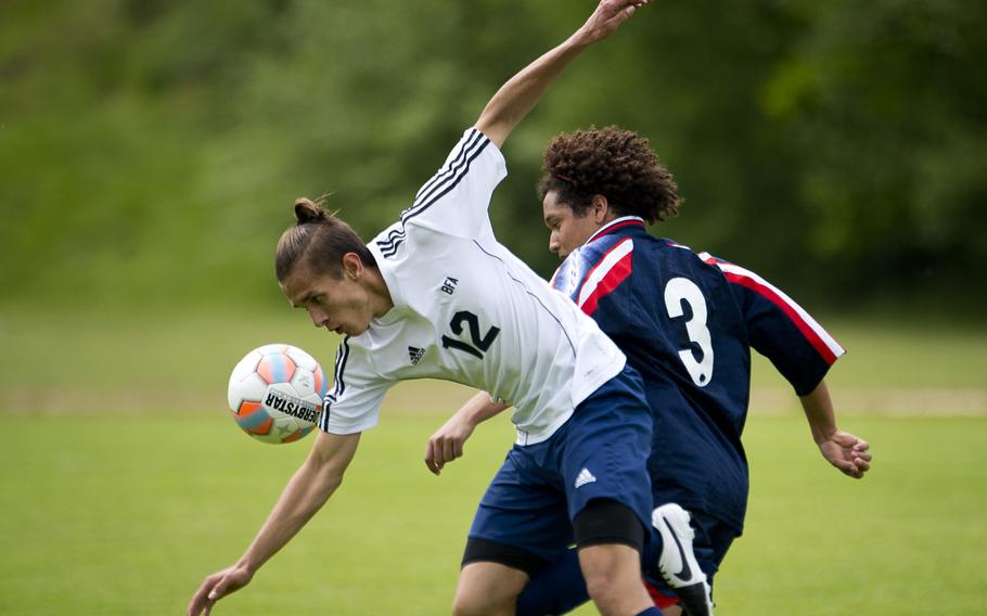 Black Forest Academy's Jeremie Kautzmann, left, and Aviano's Jaylan Robinson battle for the ball during the DODEA-Europe soccer tournament in Landstuhl, Germany, on Wednesday, May 18, 2016. Black Forest Academy won the Division II match 4-0.