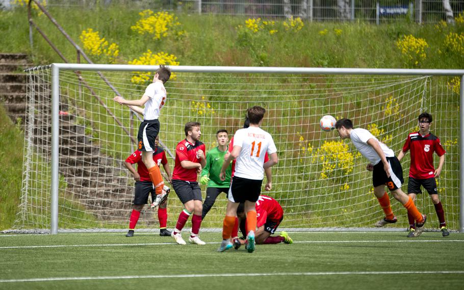 AFNORTH's Logan Harless, right, heads the ball during the DODEA-Europe soccer tournament in Landstuhl, Germany, on Wednesday, May 18, 2016. AFNORTH won the Division II match against AOSR 1-0.