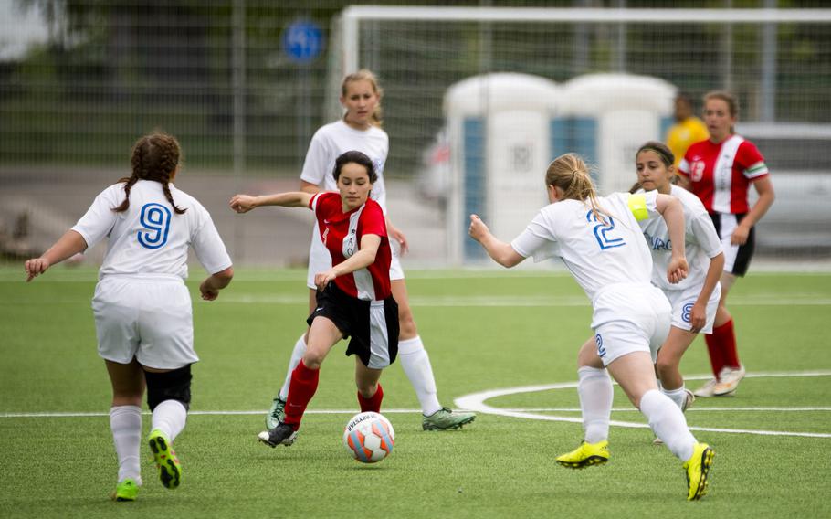 AOSR's Anne Blanchette tries to split Bitburg's defenders during the DODEA-Europe soccer tournament in Landstuhl, Germany, on Thursday, May 19, 2016. AOSR won the Division II match 2-0.