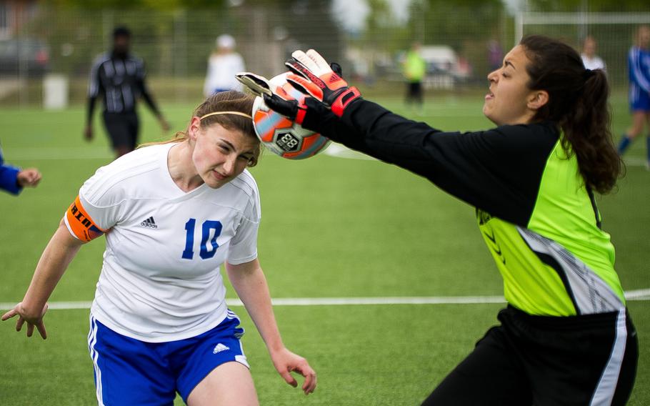 Rota's goalkeeper Ayla Muller, right, blocks a header by Hohenfels' Amelia Heath during the DODEA-Europe soccer tournament in Landstuhl, Germany, on Thursday, May 19, 2016. Rota won the Division II match 4-1.