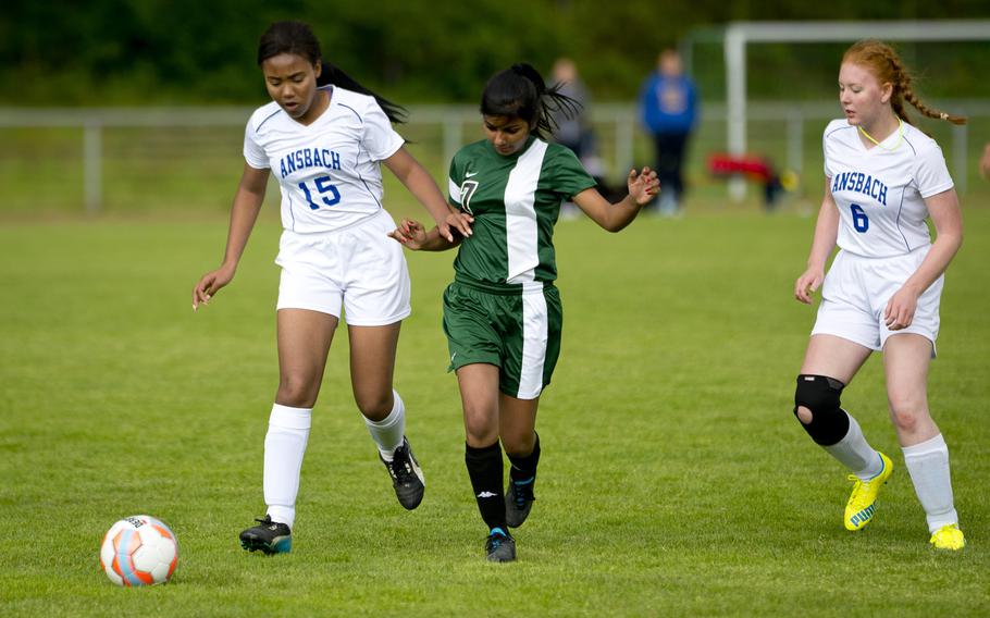 Ansbach's Emma Kabuye, left, and Jessica Livingston race Ankara's Tanvi Tejaswini to the ball during the DODEA-Europe soccer tournament in Landstuhl, Germany, on Thursday, May 19, 2016. Ansbach won the match 3-1.