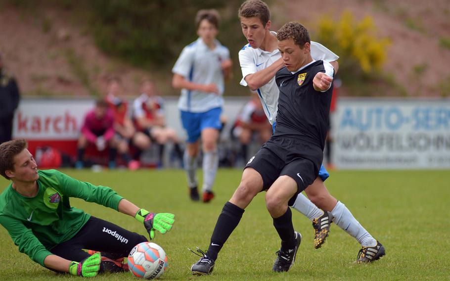 International School of Brussels keeper Alex Dedekind comes out to stop a shot by Stuttgart's Jared LuGrain as teammate Pepijn Kruidenier assists. ISB beat the Panthers 3-2 in a Division I semifinal at the DODEA-Europe soccer championships in Reichenbach-Steegen, Germany, Friday May 20, 2016. 