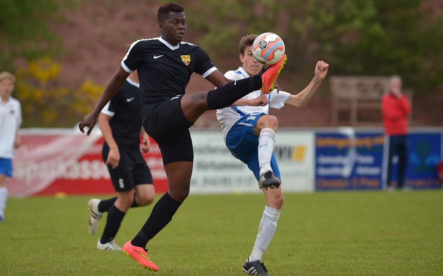Stuttgart's Faouzi Diarrassouba and International School of Brussels' Mathieu L'Hostis fight for a ball  in a Division I semifinal at the DODEA-Europe soccer championships in Reichenbach-Steegen, Germany, Friday May 20, 2016. ISB won 3-2.