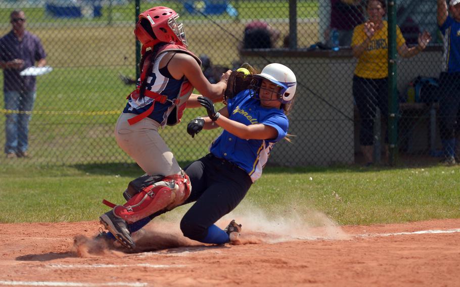 Sigonella's Marika Wojtal crashes into Bitburg catcher Justine Tila in a Division II/III game at the DODEA-Europe softball championships in Ramstein, Germany, Thursday, May 26, 2016. Wojtal scored in the Jaguars' 16-1 win.