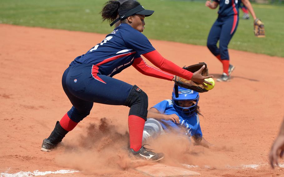 Rota's Cassidy Reyes just manages to get back to first after being caught off by a caught fly ball, as Aviano's Jazmine Bell waits for the ball. Aviano beat Rota 10-4 in a Division II/III game at the DODEA-Europe softball championships in Ramstein, Germany, Thursday, May 26, 2016. 