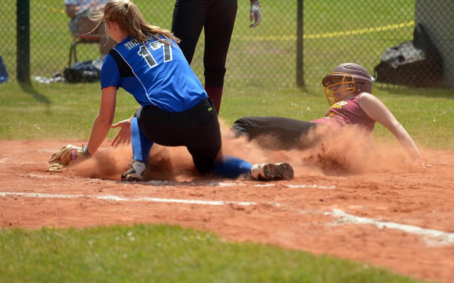 Baumholder's Brionna Buckholz beat's the tag by Hohnefels' Ellie Pirog to score a run in the Bucs' 17-5 loss to the Tigers in a Division II/III game at the DODEA-Europe softball championships in Ramstein, Germany, Thursday, May 26, 2016.