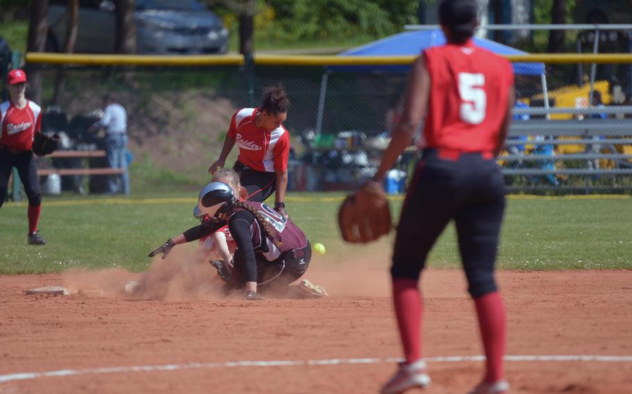 Vilseck's Isabella Brasi reaches for second base after the ball got away from Kaiser'slautern's Phoenix Whisennand in a Division I game at the DODEA-Europe softball championships in Ramstein, Germany, Thursday, May 26, 2016. Kaiserslautern won 22-3.Backing her up is Sydney Brown, at right is Tori Liggins.