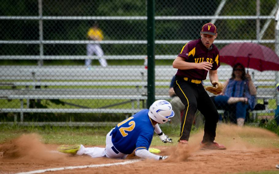 Vilseck's Tristan St. Clair, right, watches Wiesbaden's Dominic Eddings slide in to home during the DODEA-Europe baseball tournament in Kaiserslautern, Germany, on Thursday, May 26, 2016. Vilseck lost the Division I game 14-1.