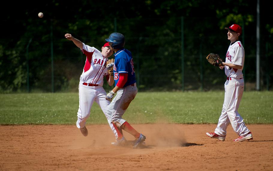 Kaiserslautern's Dustin Lund, left, throws to first after forcing Ramstein's Jonathon Oswald out during the DODEA-Europe baseball tournament in Kaiserslautern, Germany, on Thursday, May 26, 2016. Kaiserslautern lost the Division I game 6-2.