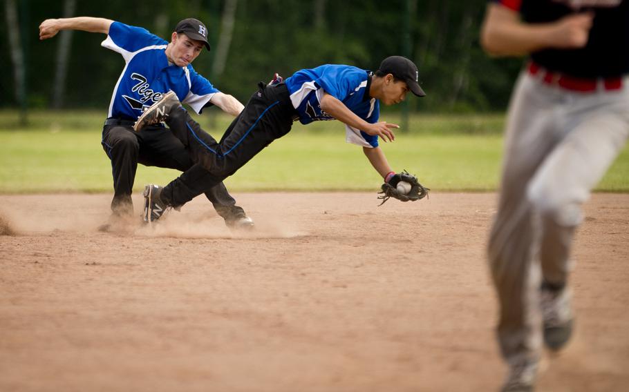 Hohenfels' Michael Wall, center, dives for the ball in front of Luke Bowser during the DODEA-Europe baseball tournament at Ramstein Air Base, Germany, on Thursday, May 26, 2016. Hohenfels lost the game against Bitburg 13-0.