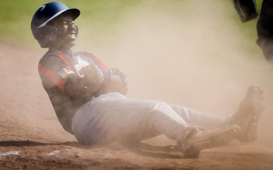 Bitburg's Jermaine Cooks holds his arm after sliding into third during the DODEA-Europe baseball tournament at Ramstein Air Base, Germany, on Thursday, May 26, 2016. Bitburg defeated Hohenfels 13-0.