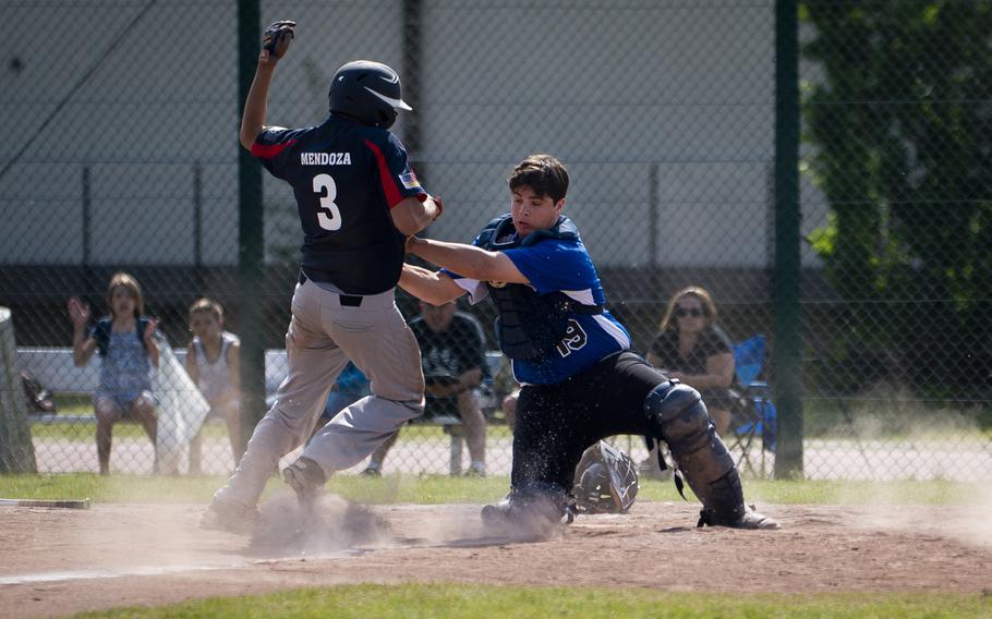 Hohenfels' Nathan Weinzetl, right, tags Bitburg's Elijah Mendoza out at home plate during the DODEA-Europe baseball tournament at Ramstein Air Base, Germany, on Thursday, May 26, 2016. Hohenfels lost the game 13-0.