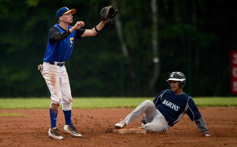 Sigonella's Austin Brehmer, left, jumps for the ball as Bitburg's Max Little slides in to second during the DODEA-Europe baseball tournament in Kaiserslautern, Germany, on Friday, May 27, 2016. Sigonella lost the game to Bitburg 8-6.