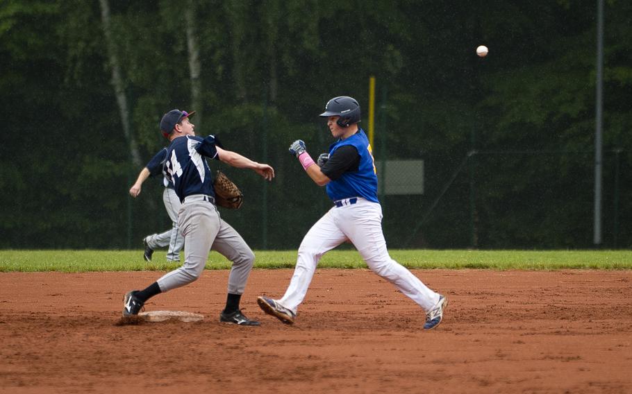 Bitburg's Matthew O'Connor, left, throws to first after forcing Sigonella's Carson Morrison out during the DODEA-Europe baseball tournament in Kaiserslautern, Germany, on Friday, May 27, 2016. Bitburg won the Division II/III game 8-6.