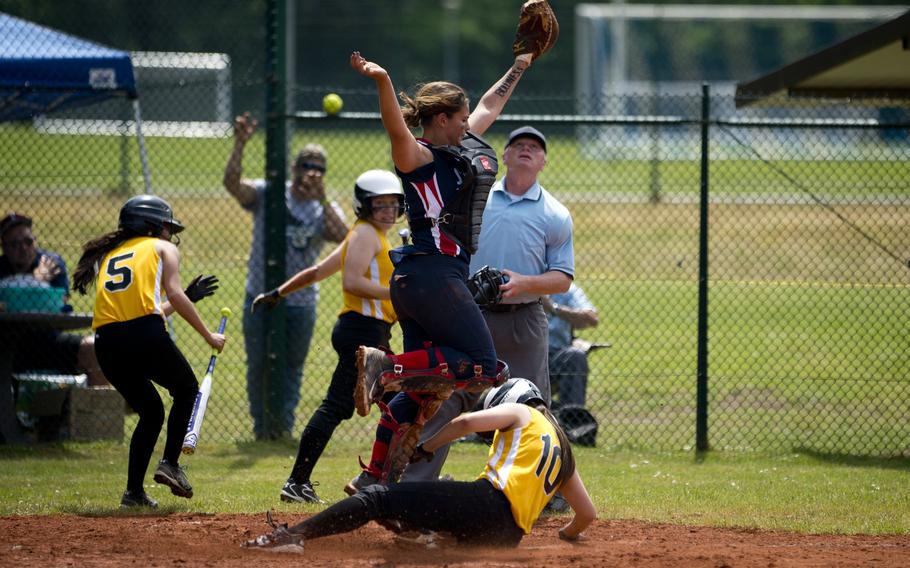 Stuttgart's Shannon Nam slides in to home underneath Lakenheath's Claire Miazga during the DODEA-Europe softball tournament at Ramstein Air Base, Germany, on Friday, May 27, 2016. Stuttgart won the Division I game against Lakenheath 16-0.