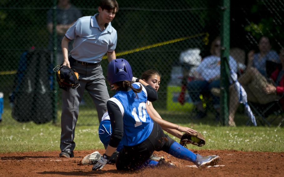 Hohenfels' Madison Otalora beats Rota's Abigail Colbert to home during the DODEA-Europe softball tournament at Ramstein Air Base, Germany, on Friday, May 27, 2016. Hohenfels won the game 14-2.