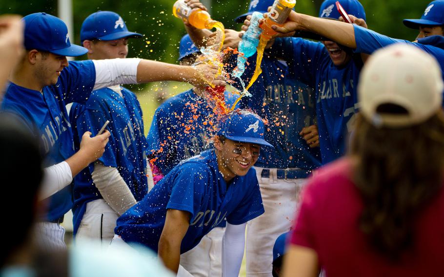 The Rota Admirals pour Gatorade on Trayton Luna in celebration of his game-winning hit after the DODEA-Europe Division II/III baseball championship at Ramstein Air Base, Germany, on Saturday, May 28, 2016. Rota defeated the Bitburg Barons 5-4 to win the title.