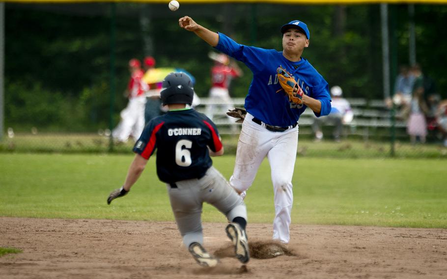 Rota's Derek Pena, right, throws to first after forcing Bitburg's Matthew O'Connor out at second during the DODEA-Europe Division II/III baseball championship at Ramstein Air Base, Germany, on Saturday, May 28, 2016. Rota defeated Bitburg 5-4 to win the title.