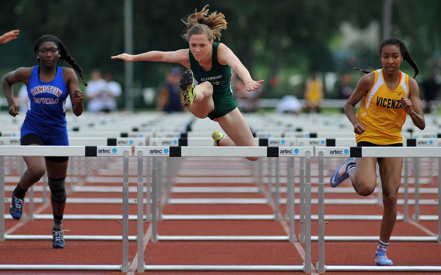 Alconbury's Olivia Sealey clears the last hurdle on her way  to defending her 100-meter hurdles title at the DODEA-Europe track and field championships in Kaiserslautern, Germany, Saturday, May 28, 2016. She won in 15.96 seconds. At left is Ramstein's Amethyst Rorie, who finished fourth, at right is runner-up Brandy James from Vicenza.