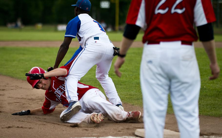 Kaiserslautern's William Frost, left, is tagged out at third by Ramstein's Myles Davis during the DODEA-Europe Division I baseball championship at Ramstein Air Base, Germany, on Saturday, May 28, 2016. Kaiserslautern lost the game 3-0.