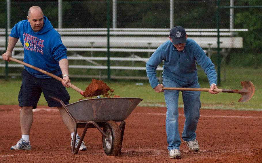 DODEA personnel try to prepare one of the softball fields at Kaiserslautern on Saturday, May 28, 2016, for a DODEA-Europe softball championship game that would never come. 