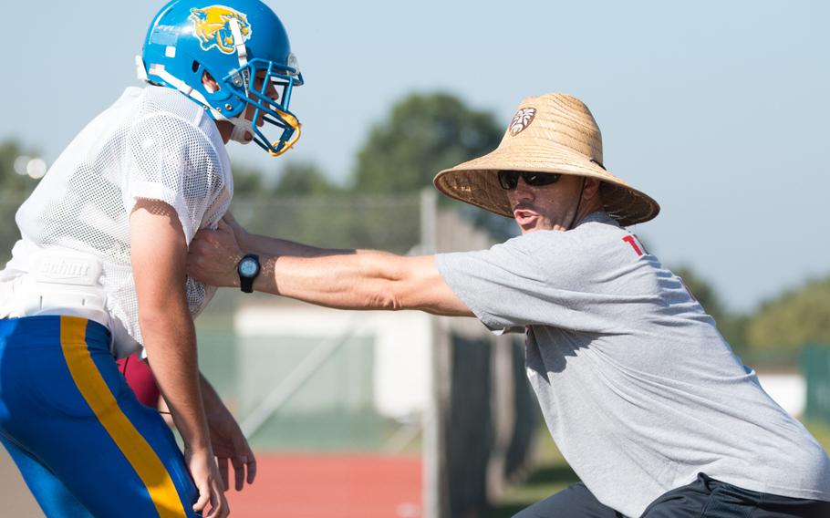 Ansbach assistant coach Dan Smith instructs his players on blocking techniques during the first half of a two-a-day practice held in Ansbach, Germany on Saturday, Aug. 27, 2016. 