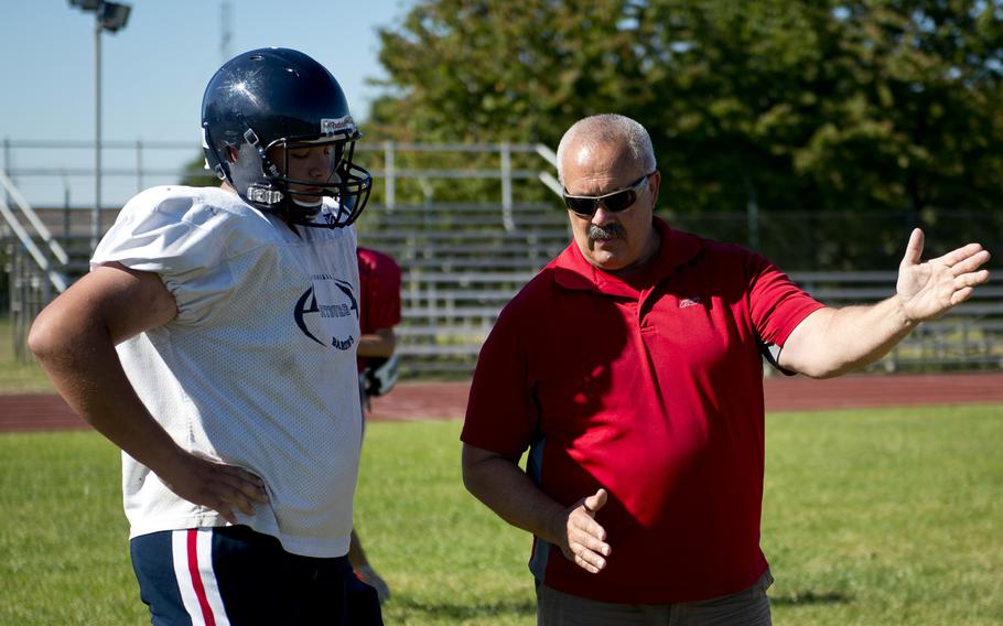Mike Laue, right, Bitburg's head football coach, works with sophomore Nicholas Scherzer during practice in Bitburg, Germany, on Thursday, Aug. 25, 2016.
