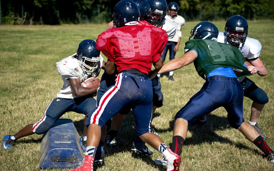 The Bitburg football team works on blocking during practice in Bitburg, Germany, on Thursday, Aug. 25, 2016.