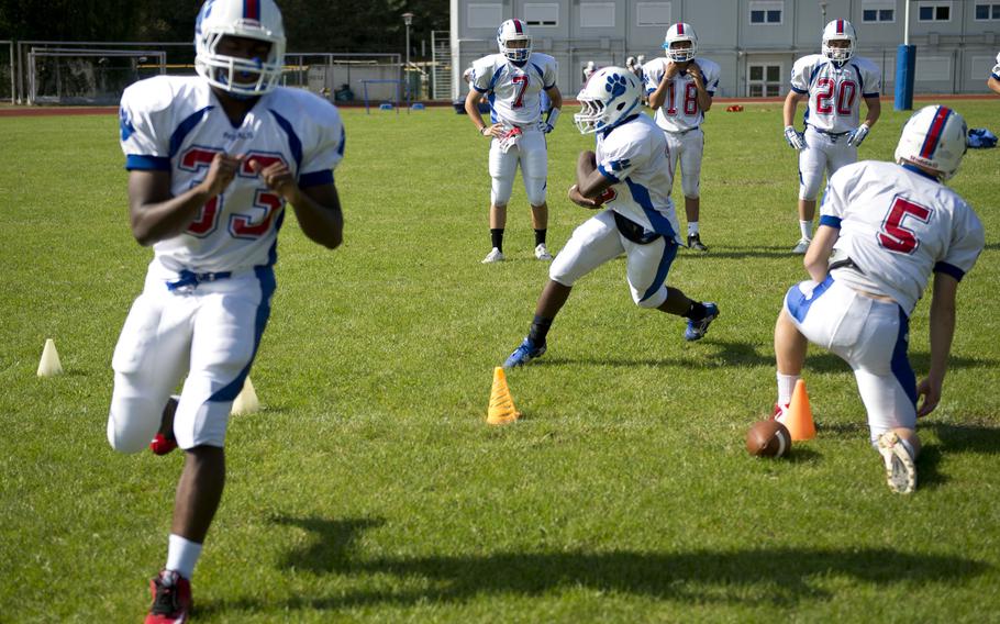 The Ramstein football team runs offensive drills during practice at Ramstein Air Base, Germany, on Tuesday, Aug. 30, 2016.