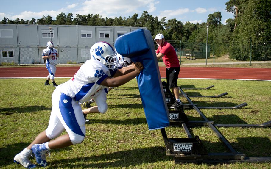 Ramstein Royals push a sled during practice at Ramstein Air Base, Germany, on Tuesday, Aug. 30, 2016.