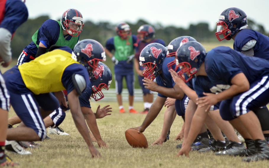 Lakenheath Lancers square up for offensive drills during after-school practice at RAF Lakenheath, England, Wednesday, Aug. 31, 2016. Ten players may have to play both sides of the ball but that the team's new off-season weight training program may help against the fatigue.