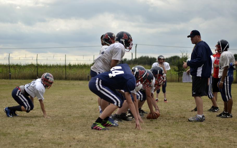 Lakenheath Lancer offensive coordinator Brian Rutleg guides  players through plays during after-school practice at RAF Lakenheath, England, Wednesday, Aug. 31, 2016. "The boys are excited to compete. That's the big deal,"  Rutleg said. 
