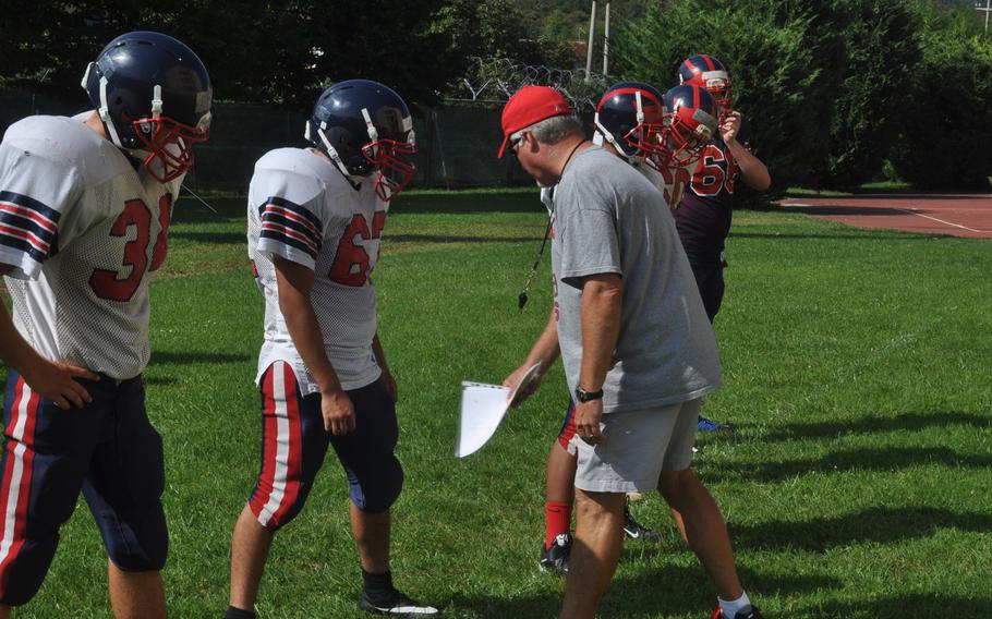 Aviano coach Rick Dahlstrom works on spacing and blocking routes with his offensive line during a recent practice.