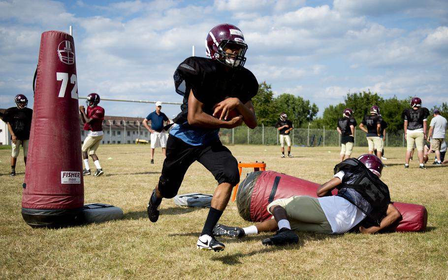 The Baumholder football team runs offensive drills during practice in Baumholder, Germany, on Wednesday, Aug. 31, 2016.