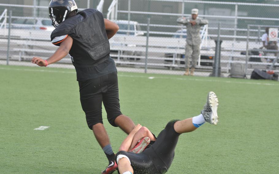 Senior fullback Mason Suarez pulls away from a Vicenza teammate during a practice drill Wednesday, Sept. 7, 2016, at Caserma Ederle in Italy.