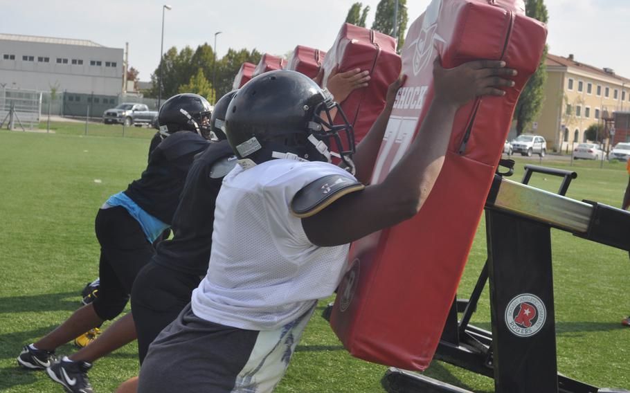 Offensive lineman move a blocking sled during a Vicenza football practice Wednesday, Sept. 7, 2016 at Caserma Ederle in Italy.