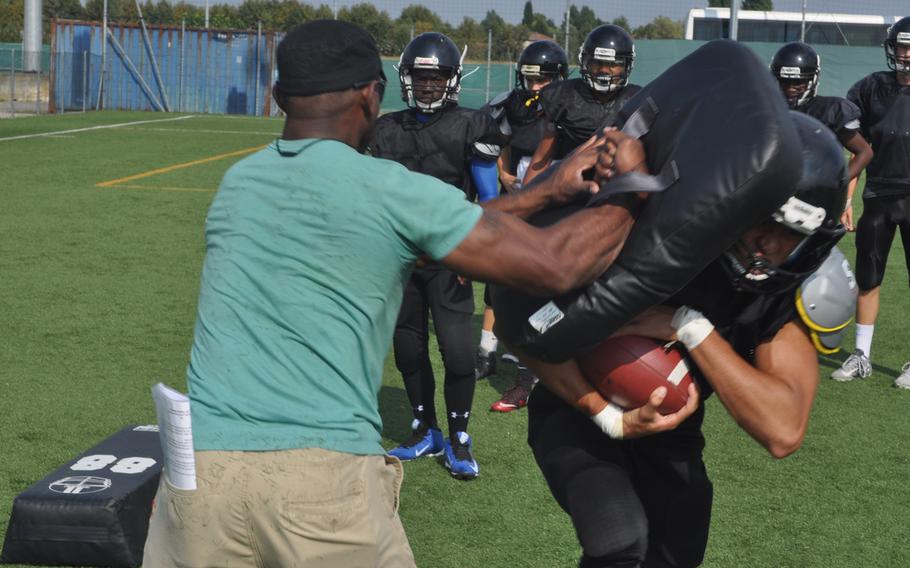 Senior running back John Silbaugh gets past assistant coach Corey Thomas during a drill Wednesday, Sept. 7, 2016, at Caserma Ederle in Vicenza, Italy.