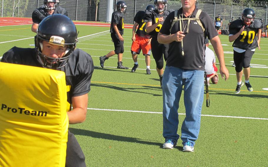 Stuttgart head coach Billy Ratliff runs blocking drills during a preseason practice. The Stuttgart Panthers are the defending Division I football champs, but only have a handful of returning players this year.